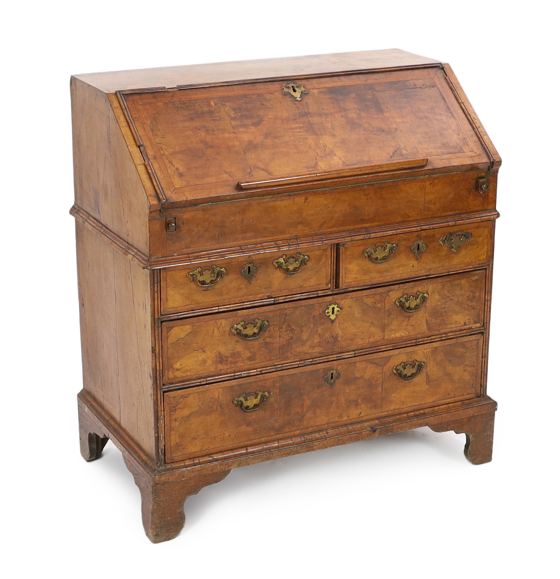 A George I figured walnut bureau, the fall enclosing an arrangement of pigeon-holes and short drawers over a well, above two short and two graduated long drawers, on bracket feet, 96cm wide, 52cm deep, 101cm high